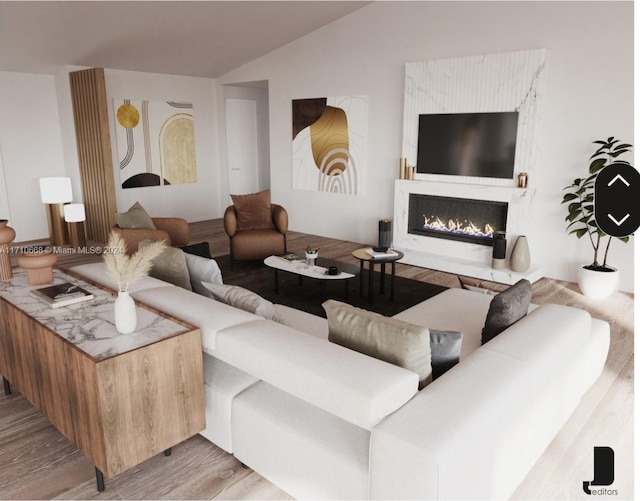 living room with vaulted ceiling and light wood-type flooring