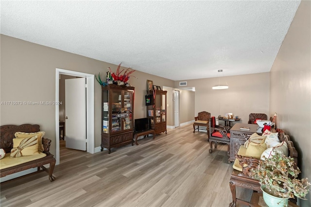 living room featuring hardwood / wood-style flooring and a textured ceiling