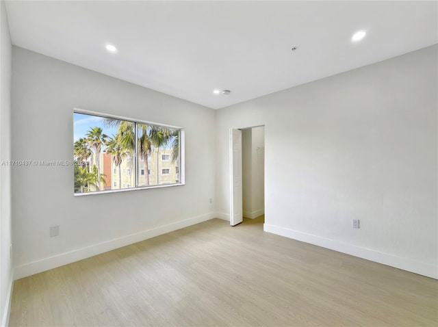 spare room with light hardwood / wood-style flooring