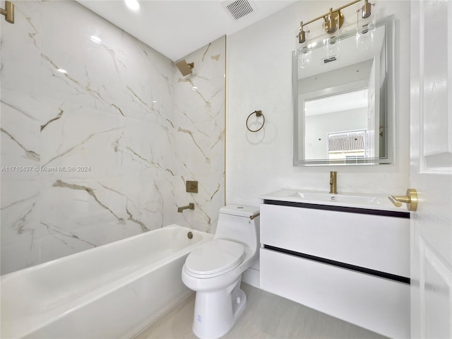 full bathroom with vanity, tiled shower / bath, and toilet