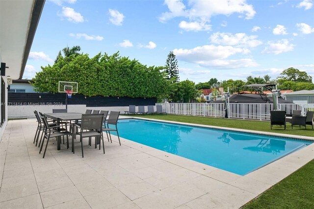 view of pool with a yard and a patio area