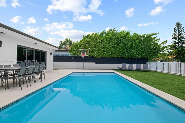 view of pool featuring a yard and a patio area