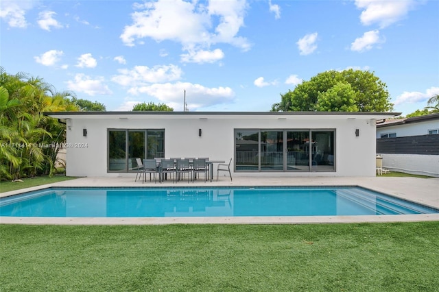 view of swimming pool with a patio and a yard