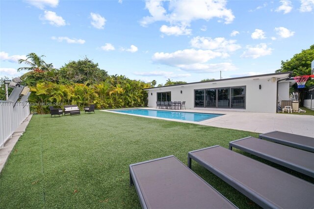 view of pool with a yard and a patio