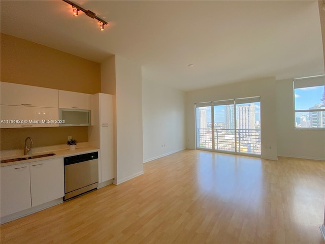 kitchen with track lighting, sink, dishwasher, light hardwood / wood-style floors, and white cabinetry