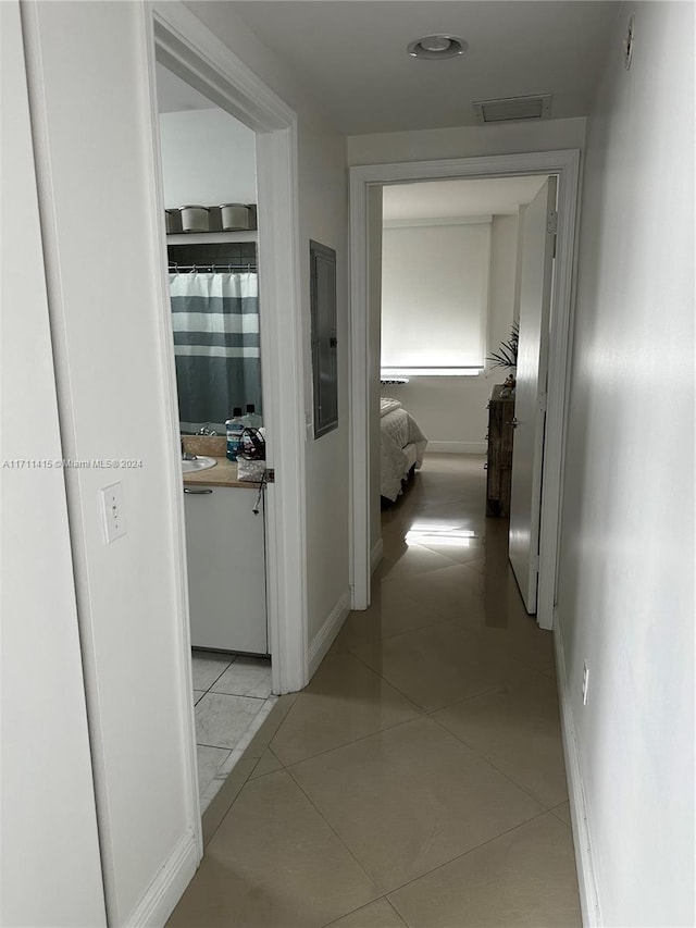 corridor featuring light tile patterned floors