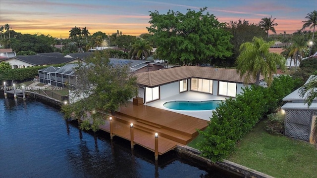 aerial view at dusk with a water view