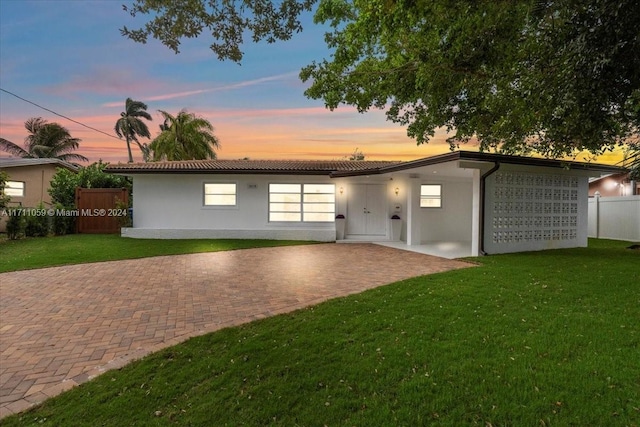 view of front of property with a yard and a patio