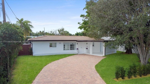 rear view of property featuring a yard