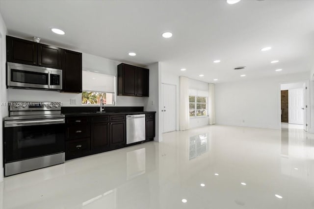 kitchen featuring sink, light tile patterned floors, and stainless steel appliances