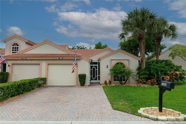 7584 Red Ruby Dr, Delray Beach, FL 33446 - view of front of property with an attached garage, a front yard, stucco siding, decorative driveway, and a tile roof