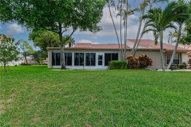 7584 Red Ruby Dr, Delray Beach, FL 33446 - back of house with a lawn and a sunroom