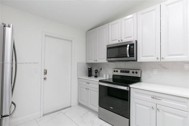 7584 Red Ruby Dr, Delray Beach, FL 33446 - kitchen with appliances with stainless steel finishes, backsplash, white cabinetry, light marble finish flooring, and light countertops