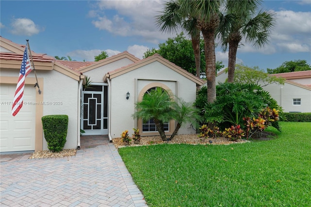 7584 Red Ruby Dr, Delray Beach, FL 33446 - view of front of property with an attached garage, a front yard, stucco siding, and decorative driveway