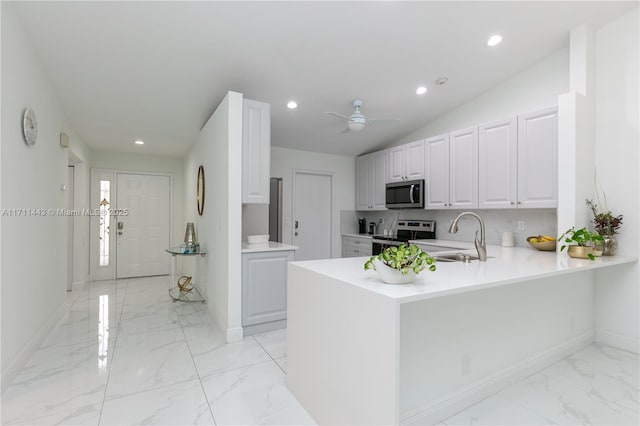 7584 Red Ruby Dr, Delray Beach, FL 33446 - kitchen featuring a sink, stainless steel appliances, light marble finish floors, baseboards, and light countertops