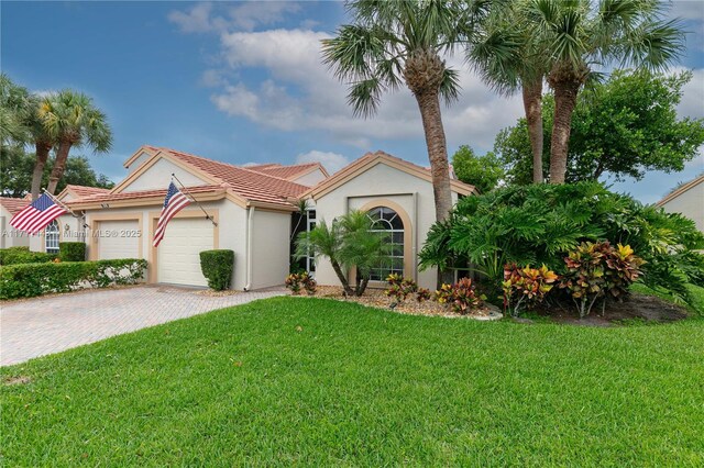 mediterranean / spanish-style house with a front lawn and a garage