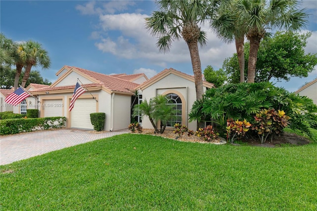 7584 Red Ruby Dr, Delray Beach, FL 33446 - view of front facade with an attached garage, a front yard, driveway, a tiled roof, and stucco siding