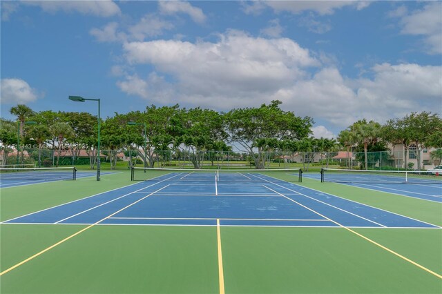 view of tennis court with basketball hoop