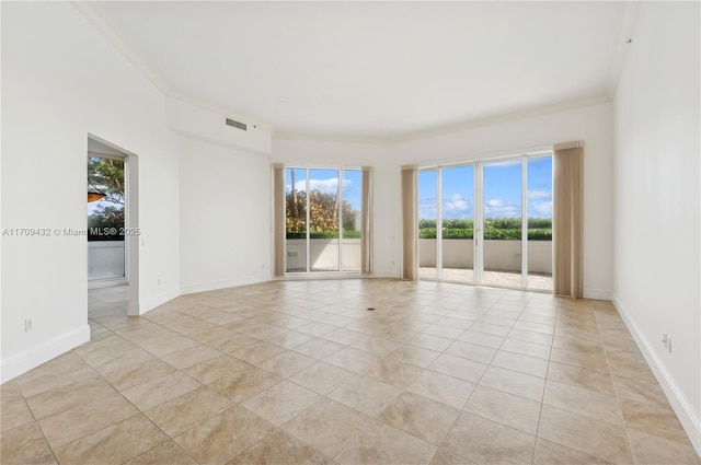 empty room with light tile patterned floors and ornamental molding