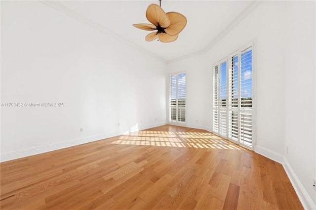 empty room featuring ceiling fan, light wood-type flooring, and ornamental molding