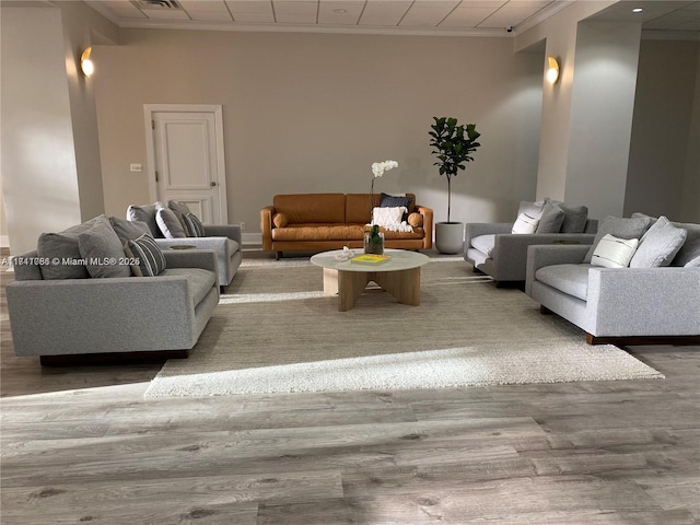 living room with hardwood / wood-style floors and crown molding