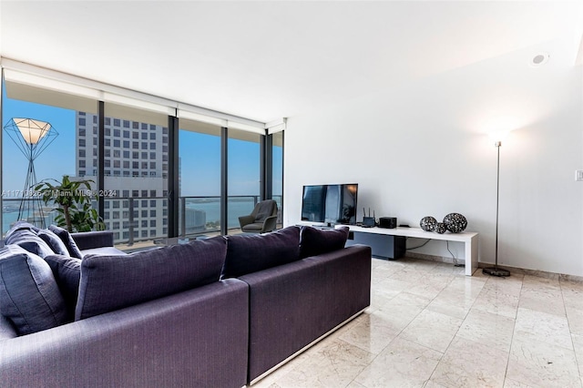 living room with floor to ceiling windows and a water view