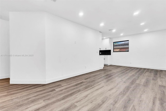 spare room featuring light wood-type flooring