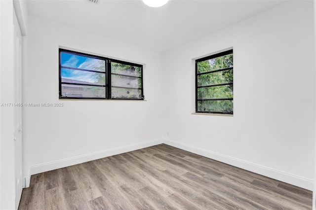 unfurnished room with a wealth of natural light and light wood-type flooring