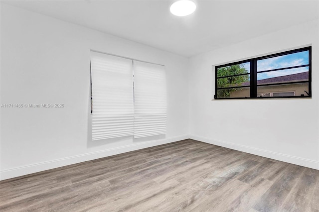 empty room with light hardwood / wood-style flooring