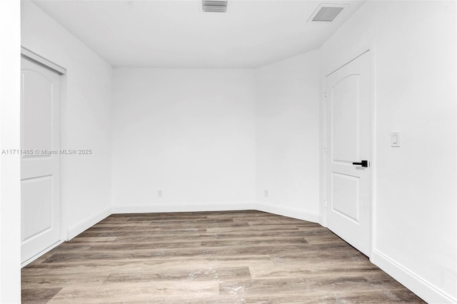 unfurnished room featuring hardwood / wood-style flooring