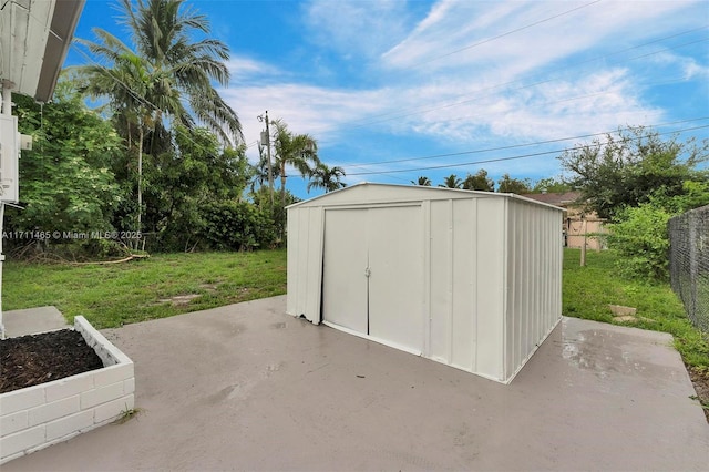 view of outbuilding featuring a yard