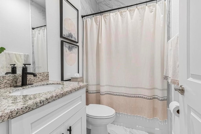 bathroom with toilet, vanity, and curtained shower