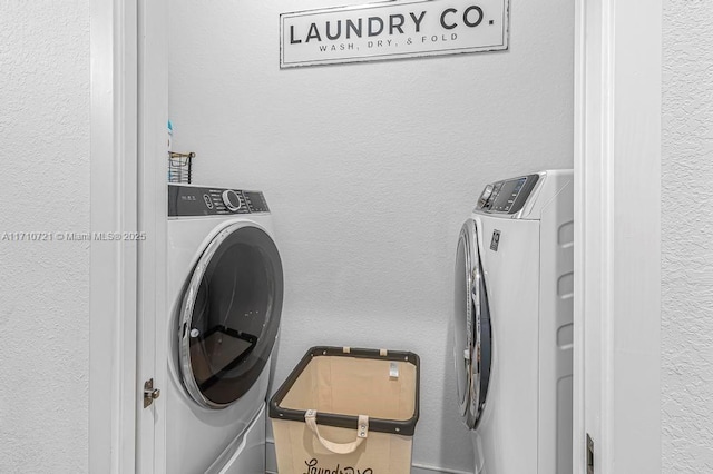 clothes washing area featuring washing machine and dryer