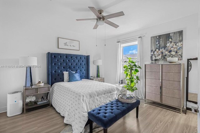 bedroom featuring hardwood / wood-style floors, access to outside, and ceiling fan