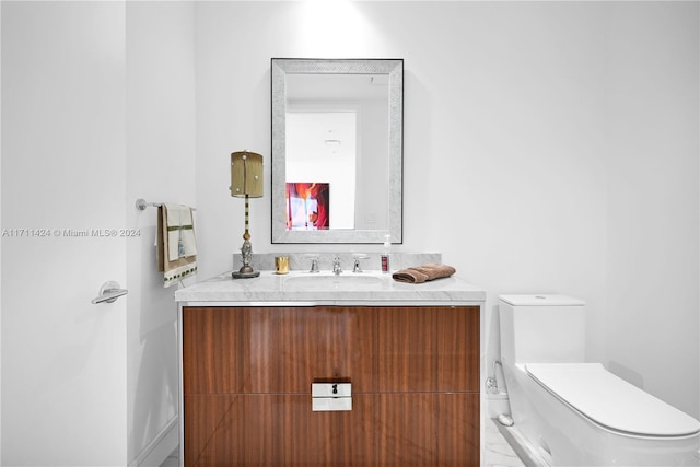 bathroom with vanity and toilet