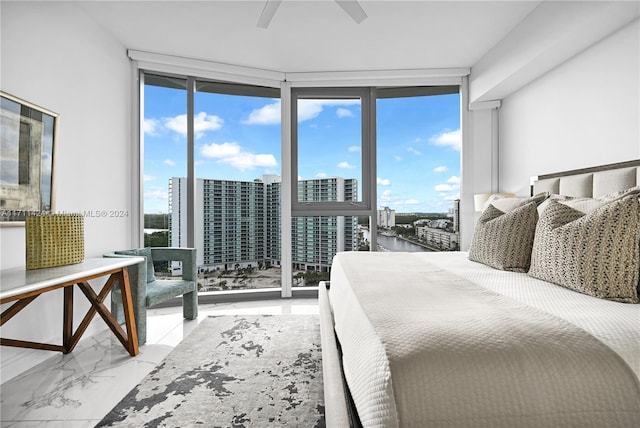 bedroom featuring access to outside, expansive windows, and ceiling fan