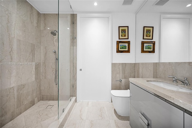 bathroom with vanity, toilet, tiled shower, and tile walls