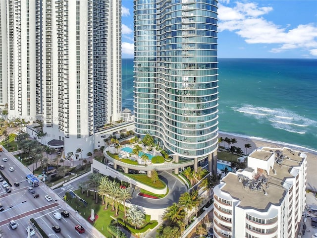 aerial view with a water view and a beach view