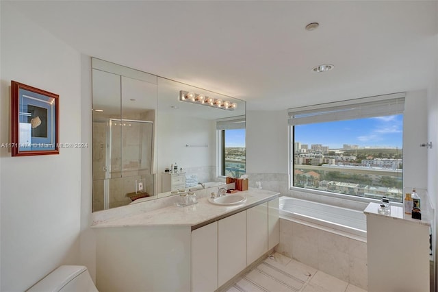 full bathroom featuring tile patterned flooring, vanity, toilet, and plus walk in shower