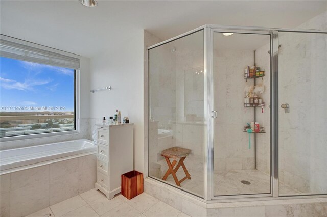 bathroom with tile patterned flooring and plus walk in shower