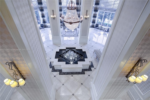 interior space with decorative columns and a notable chandelier