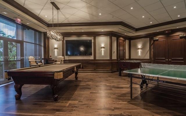 game room with dark wood-type flooring, an inviting chandelier, ornamental molding, and pool table