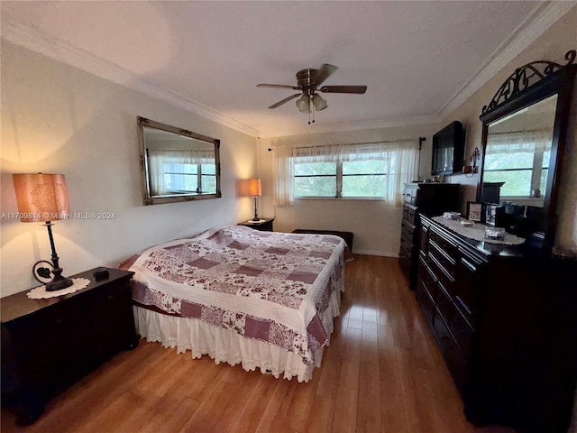 bedroom featuring hardwood / wood-style flooring, ceiling fan, and ornamental molding