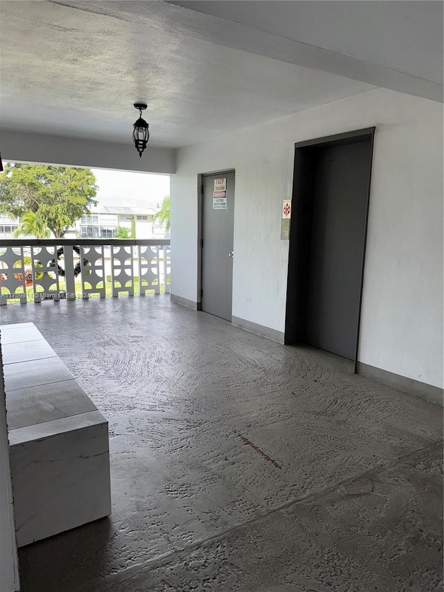 unfurnished room with a textured ceiling