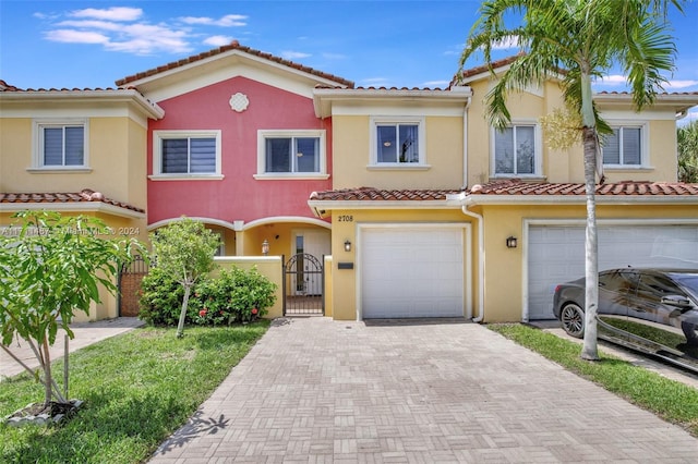 mediterranean / spanish home with a garage