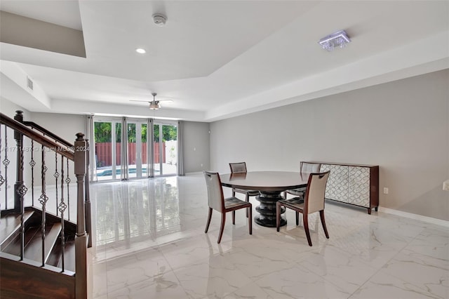 dining space with a tray ceiling