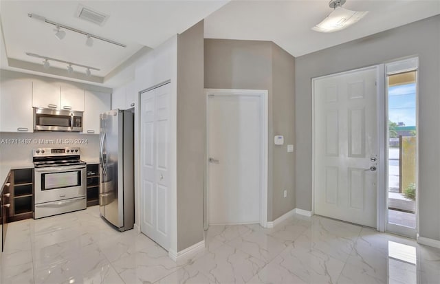 kitchen featuring rail lighting and stainless steel appliances