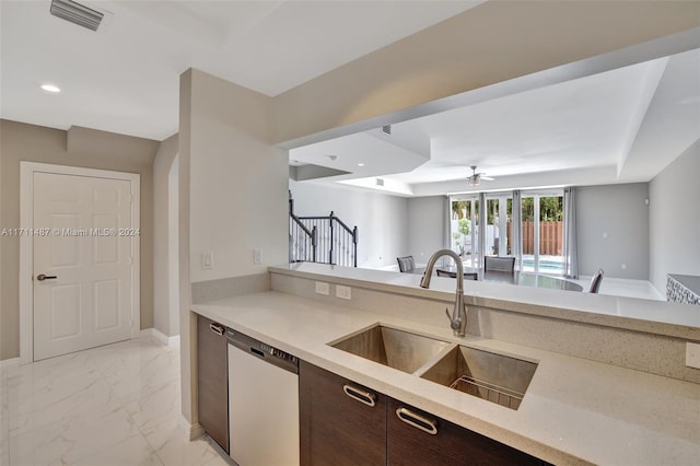 kitchen with ceiling fan, sink, stainless steel dishwasher, and dark brown cabinets