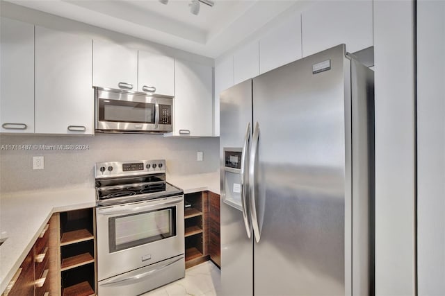 kitchen with white cabinets and appliances with stainless steel finishes