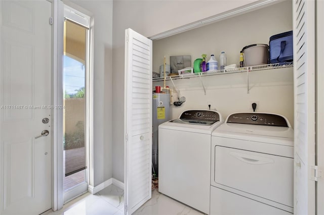 laundry room featuring water heater and independent washer and dryer